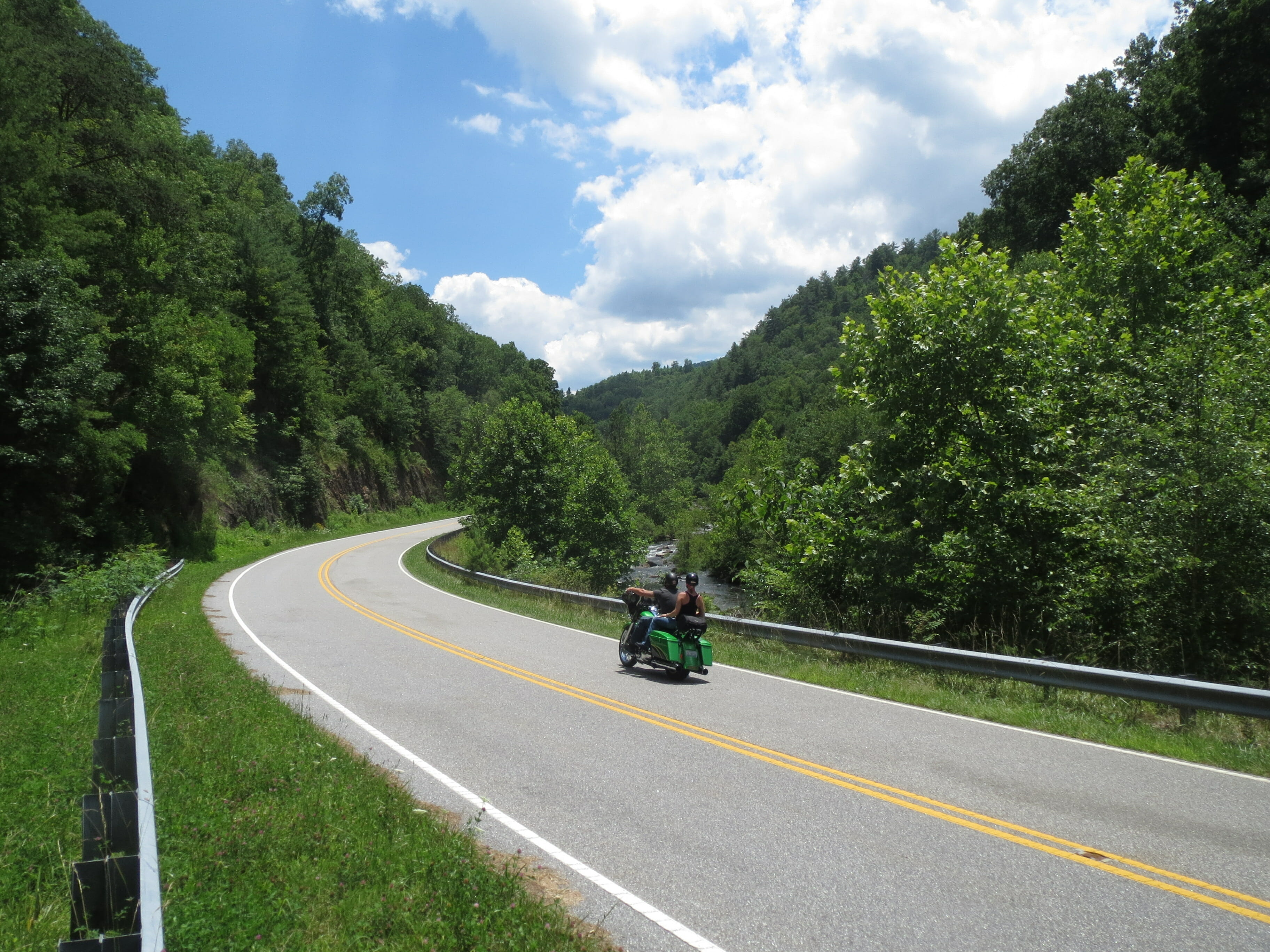 motorcyclist on highway in mountains